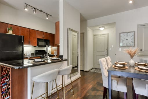a kitchen and dining room with a table and chairs and a refrigerator