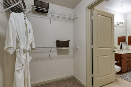 a bathroom with a shower and a towel rack and a toilet and a sink