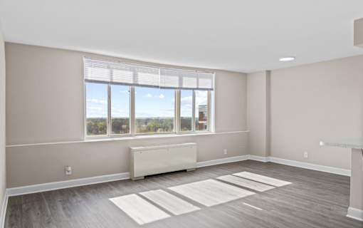 Spacious apartment interior with large windows at Dominion Towers Apartments, Arlington, VA