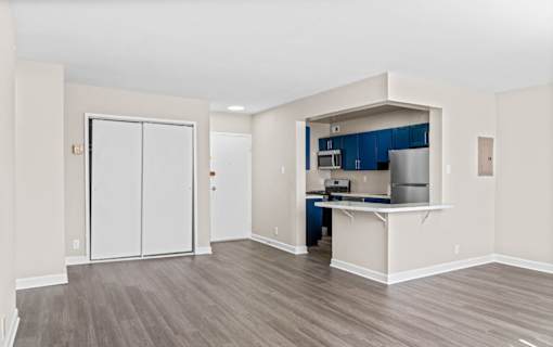Modern living area with blue kitchen cabinetry at Dominion Towers Apartments, Arlington, VA 22204