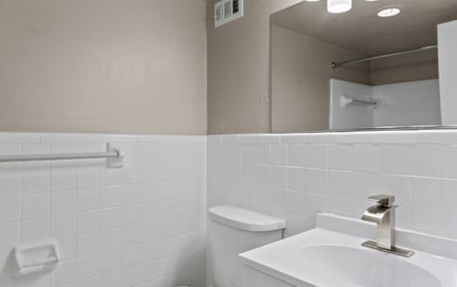 Bathroom with white subway tile and modern fixtures at Dominion Towers Apartments, Arlington