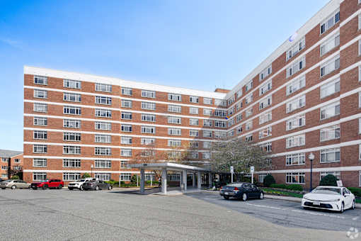 Brick apartment building with covered entrance at Dominion Towers Apartments, Arlington, VA
