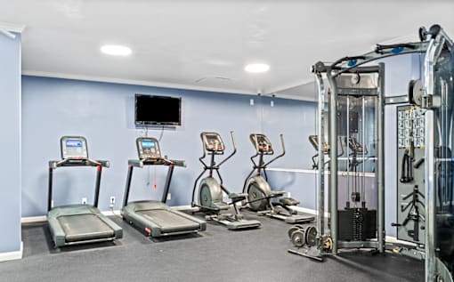 Fitness center with cardio and strength equipment at Dominion Towers Apartments, Arlington, Virginia