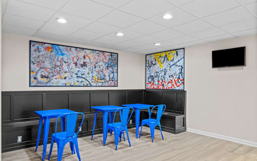 Community lounge with blue seating and artwork at Dominion Towers Apartments, Arlington