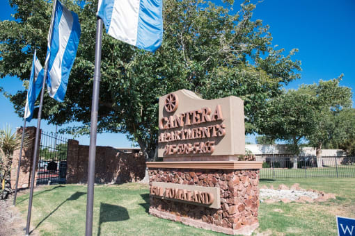 Stone entrance monument sign with landscaping at Cantera Apartments, Texas, 79935