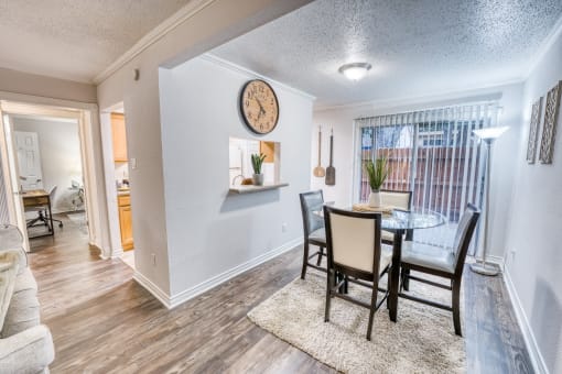 Dining area with glass table and upholstered chairs at Le Montreaux Apartments, Austin, TX 78759