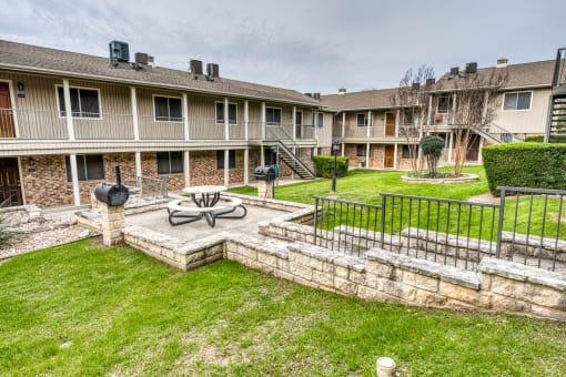 the backyard with a fire pit at Juniper Springs Apartments, Austin, TX