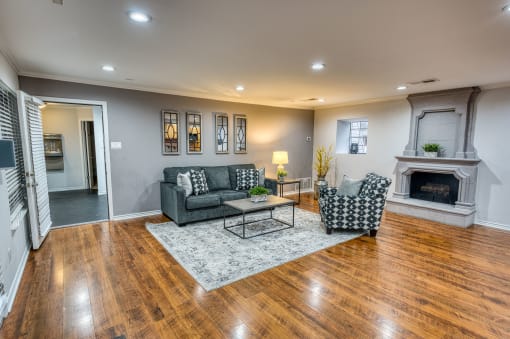 Living room with fireplace and geometric patterned furniture at Le Montreaux Apartments, Austin, Texas