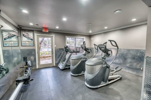 Fitness center with cardio equipment and floor mats at Le Montreaux Apartments, Austin, TX 78759