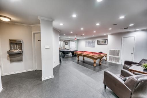 Recreation room with pool table and seating area at Le Montreaux Apartments, Austin, 78759
