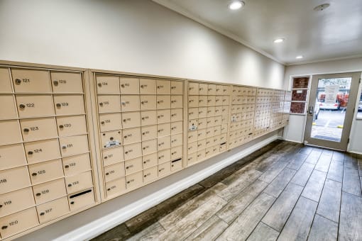 Mail room with numbered mailboxes and tile flooring at Le Montreaux Apartments, Austin