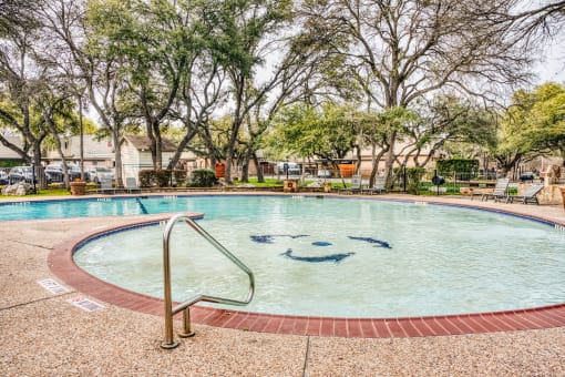 Pool area with decorative mosaic and handrail at Le Montreaux Apartments, Texas, 78759