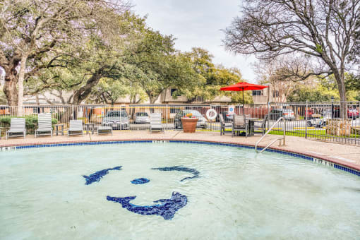 Pool with decorative anchor design and patio area at Le Montreaux Apartments, Austin, TX