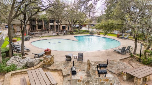 Pool area with fire pit and outdoor seating at Le Montreaux Apartments, Austin, 78759