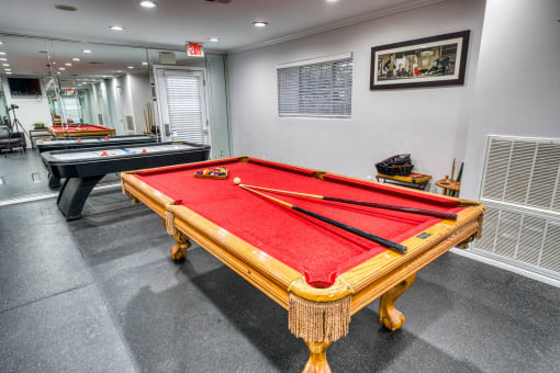 Game room with red felt pool table at Le Montreaux Apartments, Texas