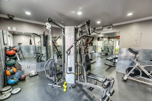 Fitness center with weight machines and exercise equipment at Le Montreaux Apartments, Austin