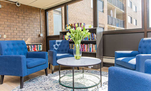 Community Library with blue chairs and a glass table.