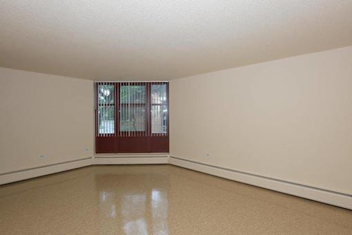 A room with a window and a closed door.