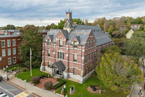A large red brick building with a tower on top.