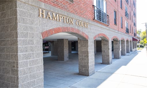 Hampton Court building entrance with arches.