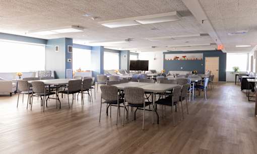 A conference room with a long table and chairs.