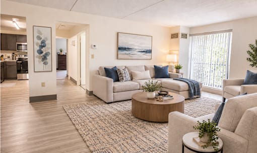 A living room with a white couch and a coffee table.