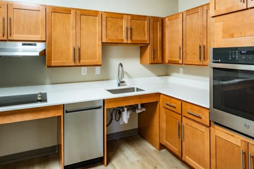 a kitchen with wooden cabinets and stainless steel appliances