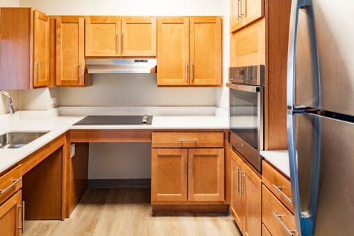 a kitchen with wooden cabinets and stainless steel appliances
