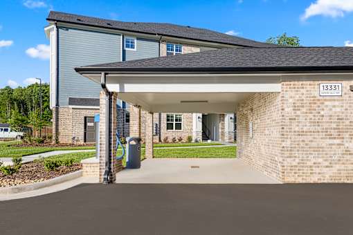 Covered parking area with brick exterior at Ardmore at Prosperity Apartments, Tennessee, 37932