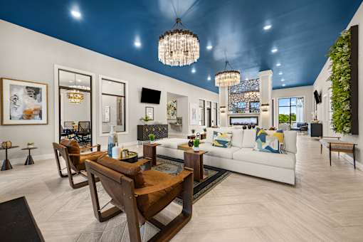 Spacious clubhouse lounge with blue ceiling and chandeliers at Ardmore at Prosperity Apartments, Knoxville, Tennessee