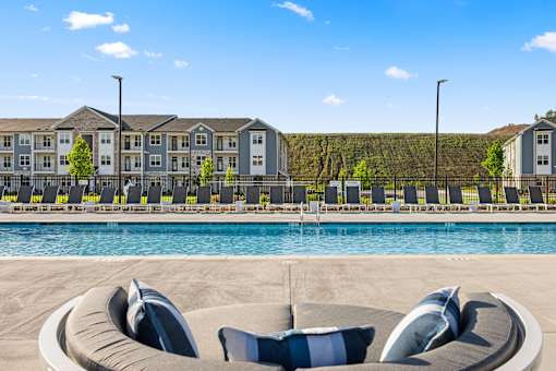 Resort style pool deck with lounge seating at Ardmore at Prosperity Apartments, Tennessee, 37932