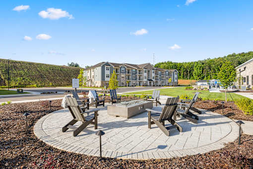 Outdoor fire pit area with adirondack chairs at Ardmore at Prosperity Apartments, Knoxville, Tennessee