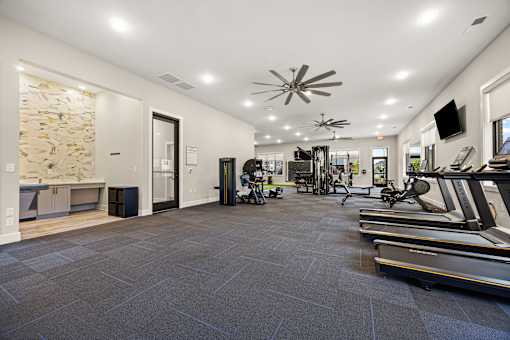 Fitness center with cardio and strength equipment at Ardmore at Prosperity Apartments, Tennessee