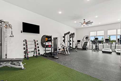A spacious home gym with a variety of equipment.