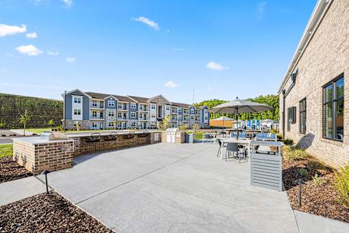 Outdoor patio with grills and dining furniture at Ardmore at Prosperity Apartments, Knoxville, TN