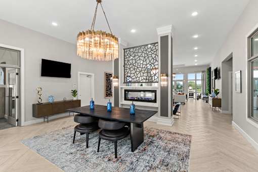 A modern dining room with a black table and chairs.