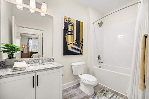 Modern bathroom with white subway tile and granite vanity at Ardmore at Prosperity Apartments, Knoxville, Tennessee