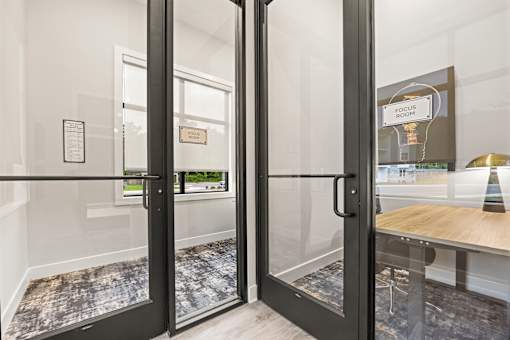 Glass door entrance to focus room with natural light at Ardmore at Prosperity Apartments, Tennessee, 37932
