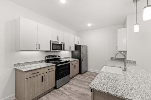 A kitchen with granite countertops and stainless steel appliances.