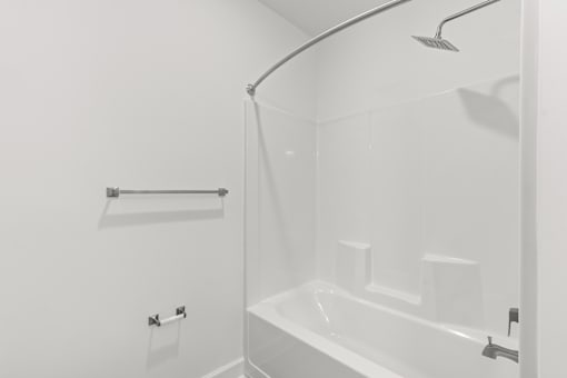 A white bathroom with a shower and a bathtub.