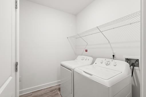 A white washing machine and dryer in a small laundry room.