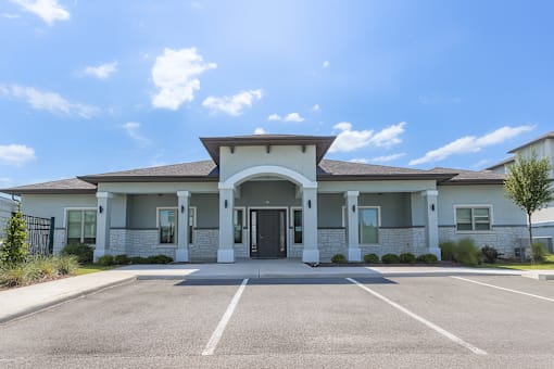 A building with a parking lot in front of it.