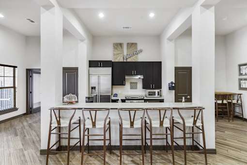 a kitchen with an island with bar stools
