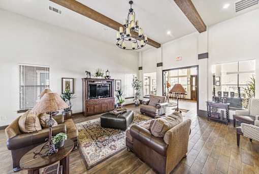 a living room with couches and chairs and a tv