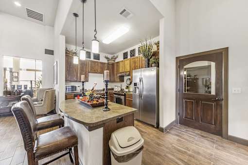 a kitchen and living room with a table and chairs