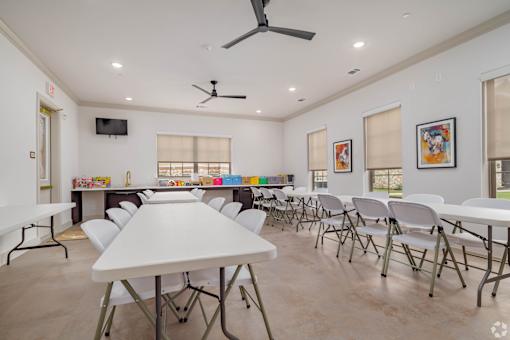 A room with a white table and chairs is shown.