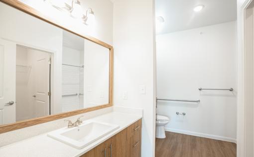 A bathroom with a white sink and a mirror.