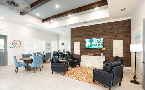 A living room with a wooden wall and a large clock on the wall.