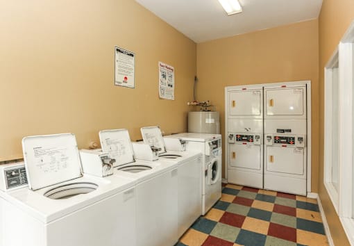 A laundry room with washers and dryers.