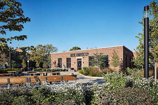 an old brick building with benches in front of it